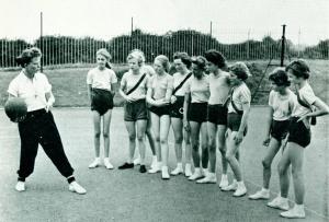 Instruction from the expert, Miss Hilary Peet, physical education mistress, who plays netball for Lancashire and who is also a member of the County swimming team. Source: Lancashire Life Magazine, November 1958